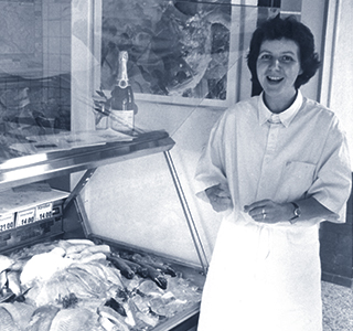 Woman in front of fish counter